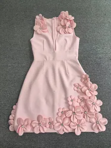 Close-up of pink V-neck dress featuring heavy handmade 3D floral appliqués with crystals.
