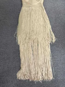 Detailed view of the layered fringe on a beige bandage evening dress