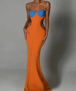 Detailed view of orange and blue bandage maxi dress with gold heart metal accents.