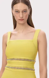 Detail view of yellow bandage party dress featuring elegant metallic bead detailing