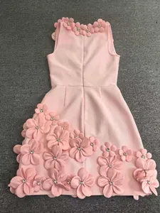 Detail view of pink sleeveless dress with 3D floral appliqués and rhinestone accents