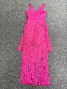 Detailed view of a magenta fringe bandage dress for red carpet events.