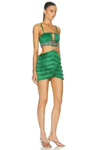Professional detailed side view of green fringed mini bandage dress with cutouts and rhinestones