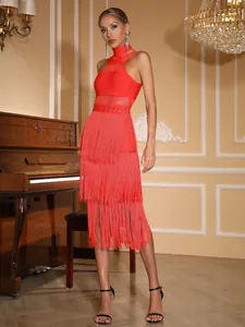 Close-up detail of red halter bandage dress featuring long tiered fringe and mesh panels