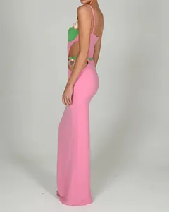 Side view of pink cutout bandage dress with green accents and heart alloy detail