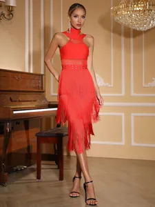 Full view of red fringe bandage dress showing halter neck mesh and rivet details