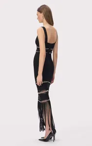 Side view of black bandage evening dress with sequin trim and long fringe tassels.