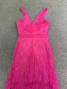 Close-up detail of magenta fringe bandage fabric and deep V-neckline construction