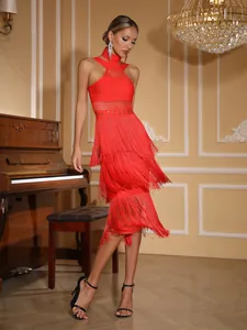 Detail view of a vibrant red high-neck halter bandage dress with multi-tier long fringe.