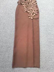 Macro detail of 3D floral appliques on coffee brown bandage evening dress