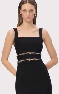 Detail view of black bandage evening dress featuring intricate waist bead embellishments