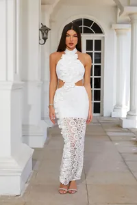 Detailed view of white halter lace dress with 3D floral ruffles and hollow-out skirt