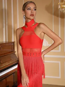 Close-up detail of red halter neck bandage dress featuring metallic studs and long fringe hem