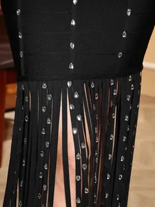 Close-up of black bandage dress with rhinestone tassels and elegant fringe detail.
