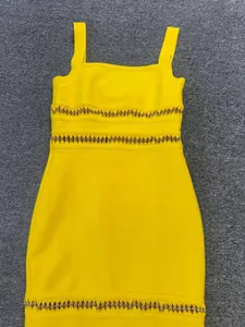 Detail view of a yellow bandage bodycon dress with sequin embellishments and cut-outs.