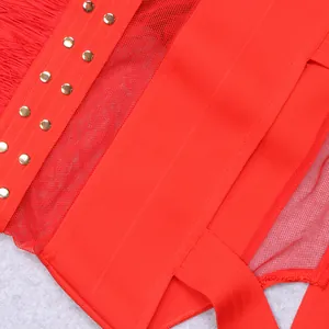 Close-up of red bandage dress featuring mesh inserts and metallic studs details