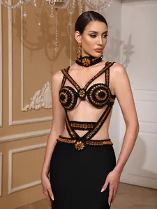 Detail of sexy black and gold beaded bandage dress with cutout design and matching choker.
