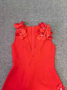 Detailed view of red bandage dress with 3D floral shoulder appliqués and crystal beads