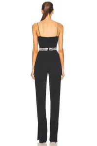 Back view of elegant black jumpsuit featuring a sparkling beaded waist and side slits