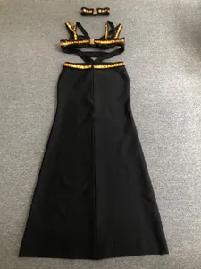Detailed view of golden beadwork on a sexy black bandage evening gown and neck ring.