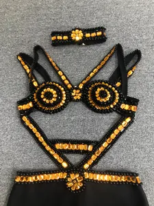 Detail view of a black bandage evening dress with amber beaded embellishments and choker.