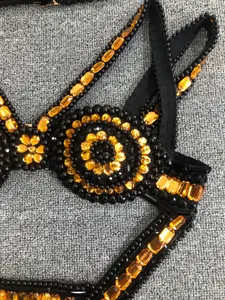 Close-up detail of luxury orange rhinestone and black beadwork on bandage evening dress