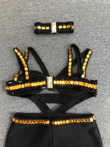Detailed view of black bandage evening dress with amber crystals and matching choker