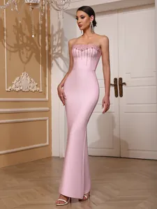 Full view of a pink strapless mermaid bandage dress with beaded sparkling details.