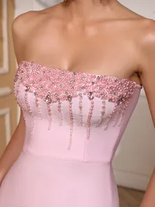 Close-up of pink bandage dress bodice with pearl and crystal embroidery detail