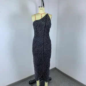 Close-up detail of a sparkly black fringe one-shoulder cocktail dress for evening parties