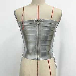 Detail view of the back zipper and metallic silver fabric of a bandage corset top