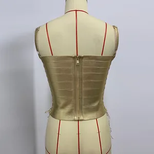 Close-up of gold bandage crop top back view featuring a metallic zipper and slim fit