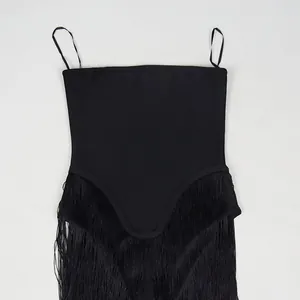 Detail view of a black designer tube jumpsuit with thin straps and elegant fringe trim
