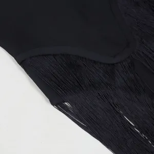 Close-up detail of black fringe and fabric texture on an elegant party jumpsuit