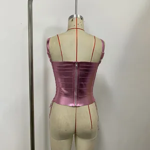 Back view detail of a pink metallic cropped camisole featuring zipper and lace-up sides