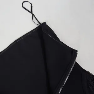 Detailed close-up showing the side zipper and non-slip strip of a black fringe jumpsuit