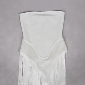 Detail view of an elegant white strapless jumpsuit with stylish fringe tassels
