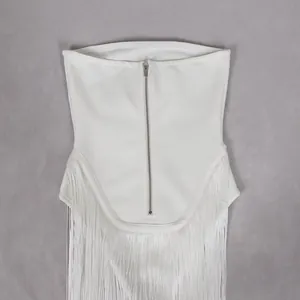 Detailed view of white strapless corset top with a silver front zipper and elegant long fringe