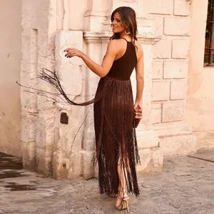 Close-up showing the dynamic movement of long brown fringe tassels on a party dress