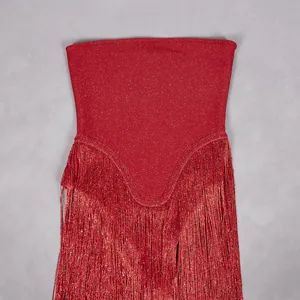 Detailed close-up of red sparkling fabric and long fringe on a strapless elegant party romper.