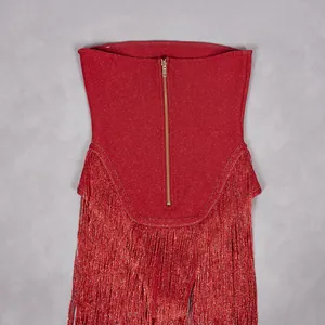 Detailed view of a red glitter tube top featuring a gold zipper and long fringe details