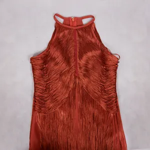 Close-up detail of a rust-red sleeveless bandage dress with tiered fringe for parties