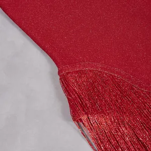 Macro close-up detail of red glitter fabric and elegant matching fringe tassels for jumpsuit