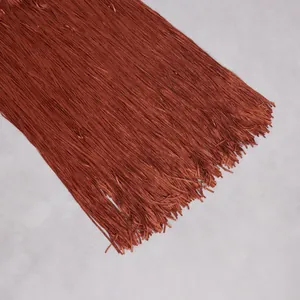 Detail shot showing the texture of dark orange silk-like tassels for party dress