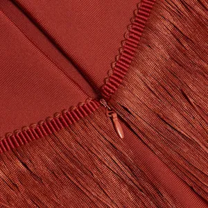 Close-up of hidden zipper and fringe detail on brick red bandage dress.