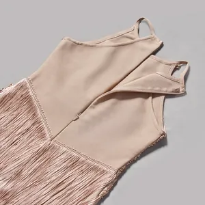 Detail view of beige bandage dress featuring hidden back zipper and long fringe texture