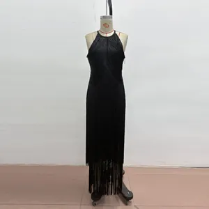 Detailed view of black sleeveless fringe bandage dress on mannequin for evening party