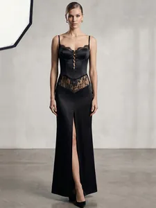 Detailed view of an elegant black satin slip dress featuring lace panels and front slit