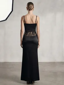 Back view of elegant black satin slip dress with delicate lace waist paneling
