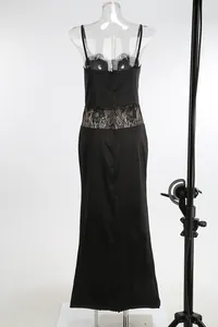 Detailed view of an elegant black camisole dress with lace patchwork on mannequin